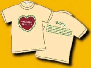 A 100% cotton creamy beige shirt, on the front is a brick red heart surrounded by green. Inside the heart in white letters it says: Within the heart of each community, everyone belongs. On the back is a dictionary definition of belong. This is an original Dan Wilkins design. Only 1 left - Child Medium (10-12)