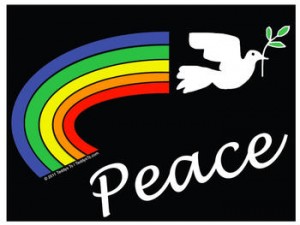 Black tshirt with white dove holding an olive branch. Behind it is a hand painted (by Teddy) rainbow. We have this shirt in adult and children's sizes.